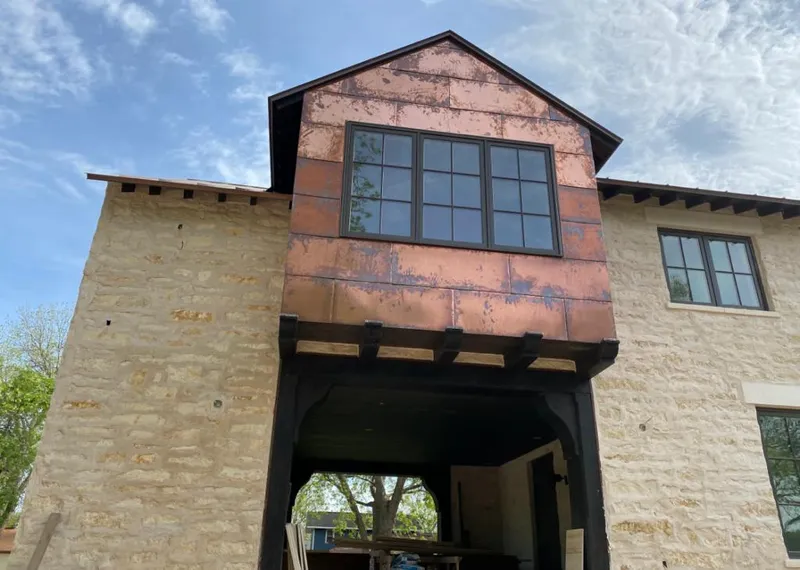 Copper metal panel facade on a stone building for Metal Roof Coating in Portage Lakes